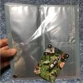 The inside of the Pikmin e+ binder with a card for scale.